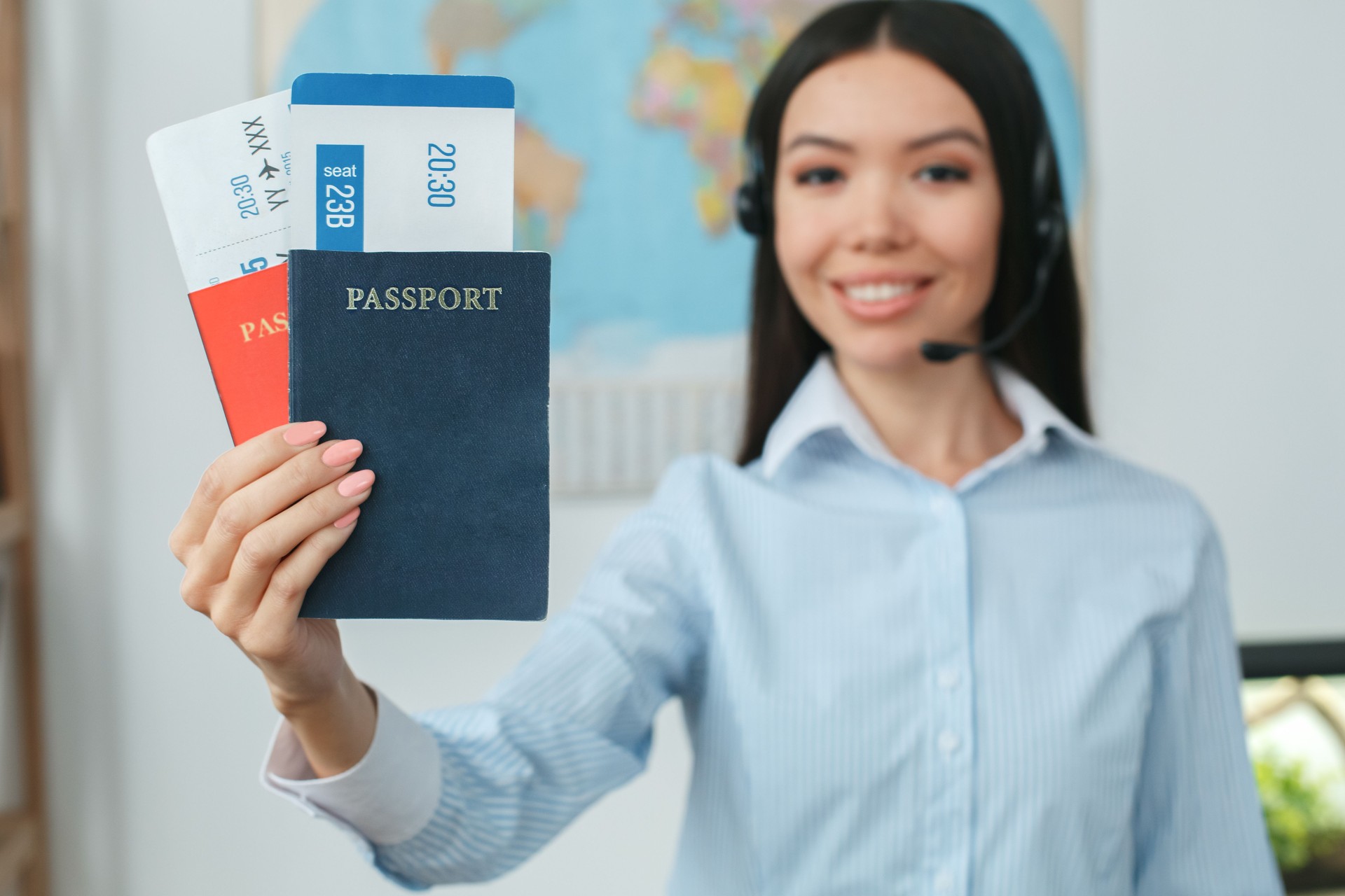 Young female travel agent consultant in tour agency holding documents